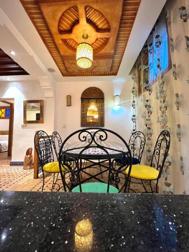 a dining room with a table and chairs at Dar sultana in Rabat