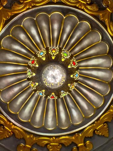 a ceiling with a stained glass window in a building at Dar sultana in Rabat