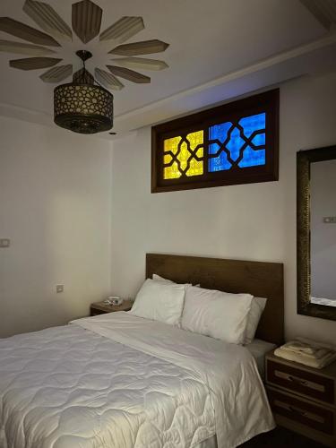 a bedroom with a bed and a stained glass window at Dar sultana in Rabat