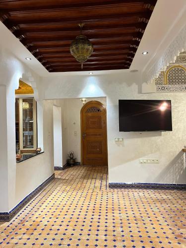 a large room with a tv on the wall at Dar sultana in Rabat