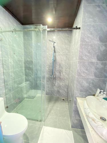 a bathroom with a shower and a toilet and a sink at Sadakham Royal View Hotel in Luang Prabang