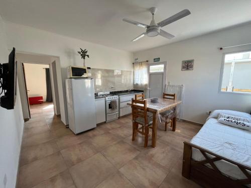 a kitchen with a refrigerator and a table in it at El Remanso in San José