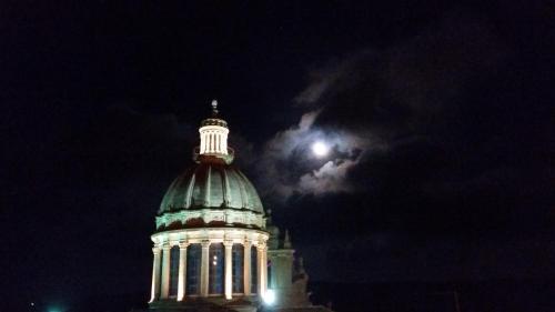 a building with a moon in the sky behind it at Iblainsuite in Ragusa