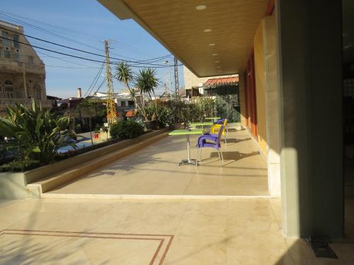 a purple chair sitting on a patio at La Tourelle in Jounieh