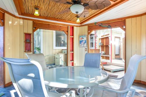 a dining room with a glass table and chairs at Pahoa Sunrise Paradise Gardens in Pahoa