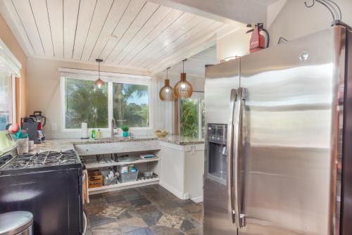 a kitchen with a large stainless steel refrigerator at Pahoa Sunrise Paradise Gardens in Pahoa