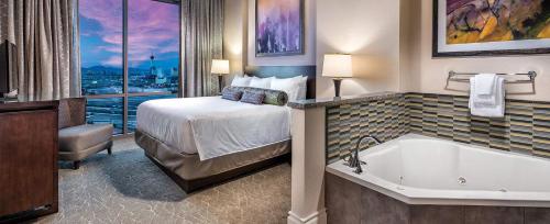 a hotel room with a bed and a bath tub at Las Vegas Desert Blue by HelloVacay in Las Vegas
