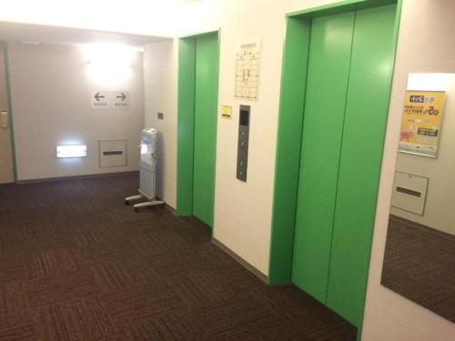 a hallway with green walls in a building at R&B Hotel Hakata Ekimae 1 - Vacation STAY 40717v in Fukuoka
