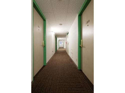 an empty hallway in an office building with green and white walls at R&B Hotel Hakata Ekimae 1 - Vacation STAY 40717v in Fukuoka