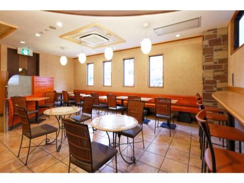 a restaurant with tables and chairs in a room at R&B Hotel Hakata Ekimae 1 - Vacation STAY 40717v in Fukuoka