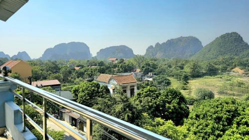 a balcony with a view of a valley with mountains at Vi Hotel in Vũ Lâm