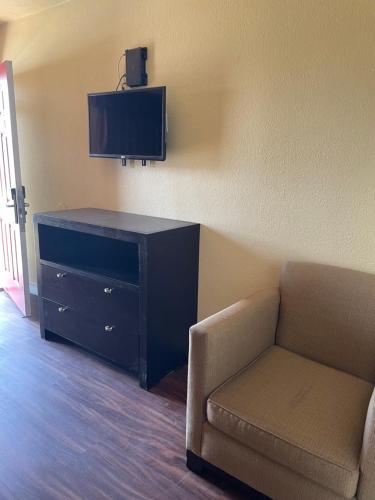 a living room with a couch and a tv and a chair at Cloud 9 in Cypress