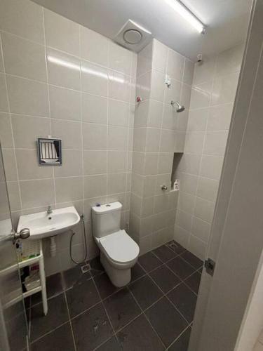 a bathroom with a toilet and a sink at Hz homestay in Simpang Ampat