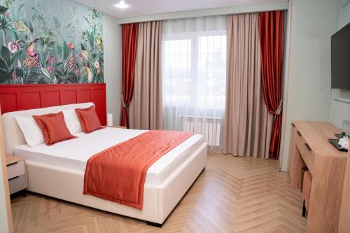 a bedroom with a bed and a painting on the wall at Terrenkur boutique-hotel in Almaty