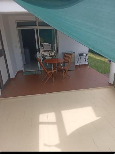 a view of a patio with a table and chairs at Fare Yana 2 in Punaauia