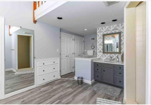 a large bathroom with a sink and a mirror at Villa on a hill with indoor heated salt water pool in Boyertown