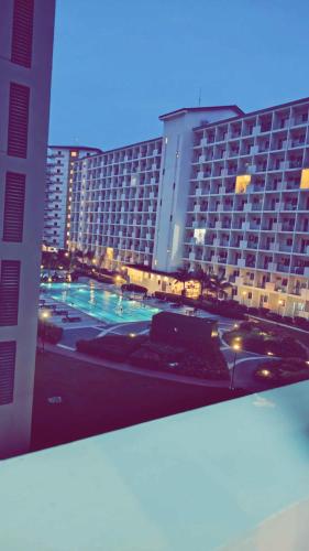 a view of a large building with a parking lot at Staycation by Estelle in Manila