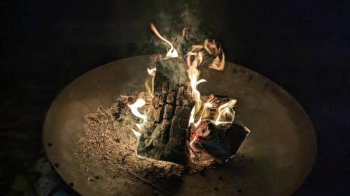 a metal table with a fire on top of it at JOKIJOKI Hakuba in Hakuba