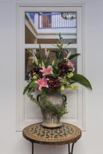 a vase filled with flowers sitting on a table at Villa Maroc Essaouira in Essaouira