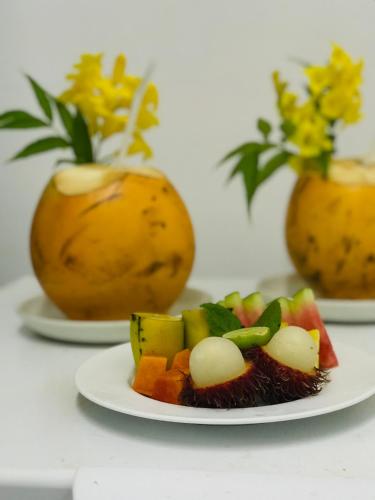 a plate of fruit and vegetables on a table at Regent Heights in Kandy