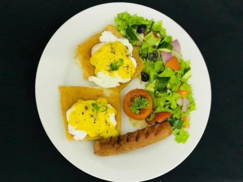 a plate of food with eggs and a salad at Regent Heights in Kandy