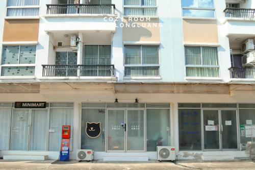 a store front of a building with a sign on it at Cozy room in Khlongluang Ill - Self Check-in in Khlong Luang