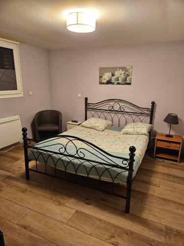 a bedroom with a bed with a lamp and a chair at Gite lapins in Fromelles