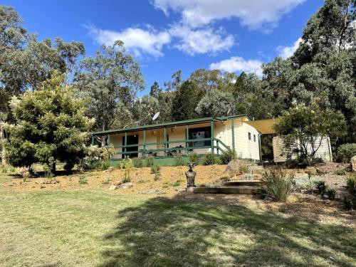 une maison au milieu d'une cour dans l'établissement Green Tree Cottage rural serenity near town, à Mudgee