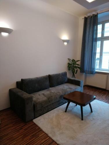 a living room with a couch and a coffee table at Luxusní byt v centru - Free Parking in Karlovy Vary