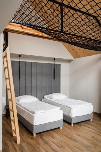 two bunk beds in a room with wooden floors at Grand Chotowa Hotel Spa & Resort in Chotowa