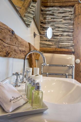 a bathroom sink with two soap bottles on it at Boutique - Hotel Adara in Lindau