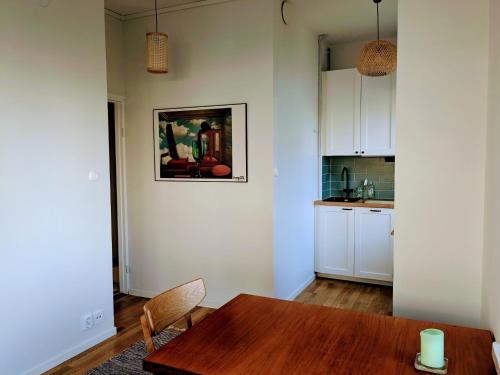 eine Küche mit einem Holztisch in einem Zimmer in der Unterkunft Artistic 2-Bedroom full of light in Helsinki