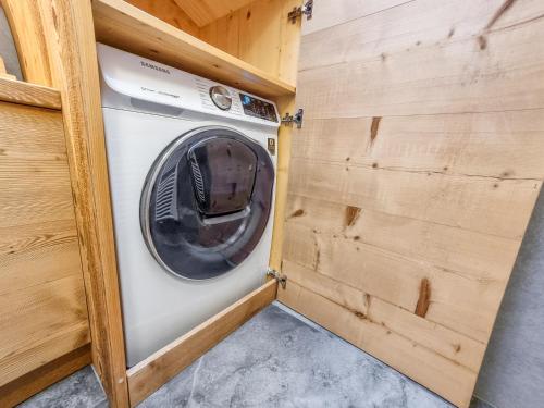 a washer and dryer in a tiny house at Casa Panoràma in the heart of the Dolomites, Moena in Moena