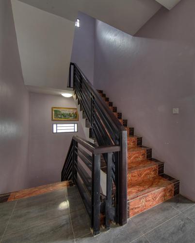 a staircase in a house with a wooden railing at Kalinga Art Home Guest House in Siem Reap
