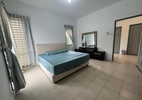 a bedroom with a bed and a mirror at Essential Homestay in Tawau - Bandar Sri Indah in Kampong Parit