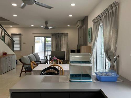 a kitchen and living room with a counter top at Essential Homestay in Tawau - Bandar Sri Indah in Kampong Parit