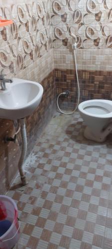a bathroom with a sink and a toilet at MANI's in Chandragiri