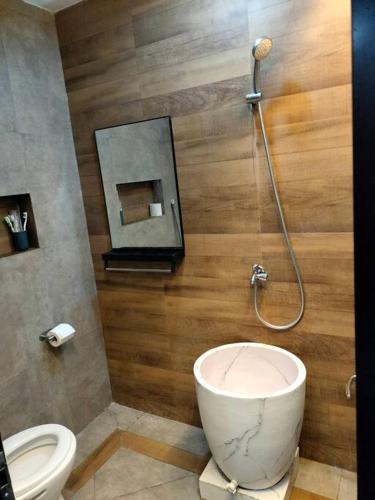 a bathroom with a toilet and a sink and a shower at Taman Salak Homestay -5BR Entire House in Madiun