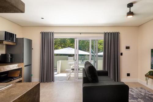 a living room with a couch and a table at Beach Wood Boutique Hotel & Resort in Ballito