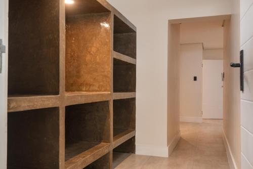 a hallway with wooden shelves in a house at Beach Wood Boutique Hotel & Resort in Ballito