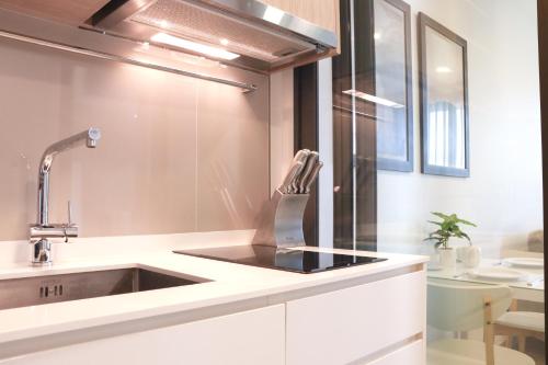 a kitchen with a sink in a white kitchen at Sky Park Laguna 1 bedroom Golf View in Bang Tao Beach
