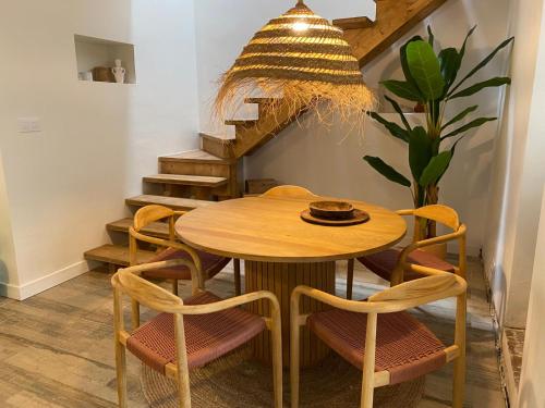 a dining room table with chairs and a chandelier at Jalon townhouse in Jalón