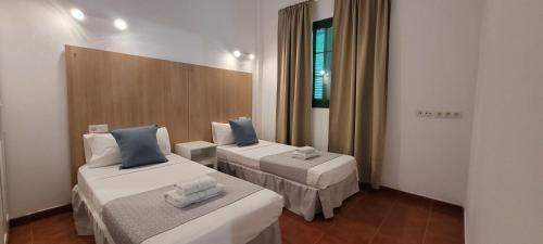 En eller flere senge i et værelse på Sabbia Suites El Muellito