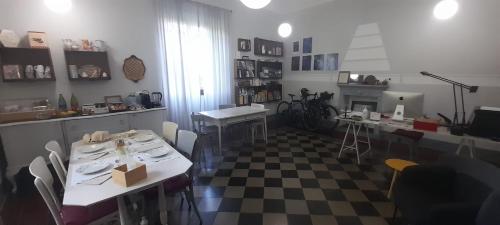 a room with two tables and a checkered floor at Langhe di Liguria B&B in Piana Crixia
