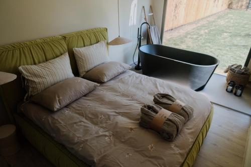 a bed in a room with a couch and a window at 99 Maison by Noire - Deluxe Bungalow Sibiu in Sibiu
