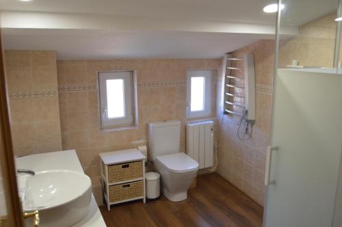 a bathroom with a toilet and a sink at Vut Casa de los Leales - Ávila in Ávila