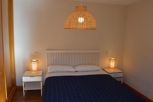 a bedroom with a blue bed and two night stands at Vut Casa de los Leales - Ávila in Ávila
