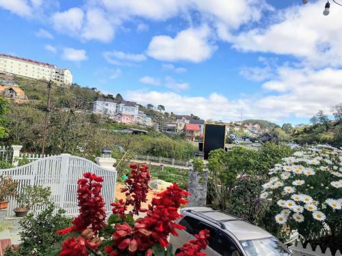 a car parked next to a bunch of flowers at Tomorrow Homestay Đà Lạt in Da Lat