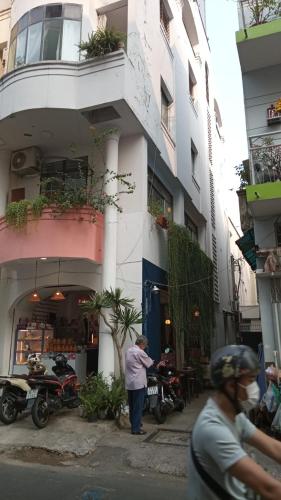 a man standing in front of a building at CAMP Dakao a curated accomodation in Ho Chi Minh City