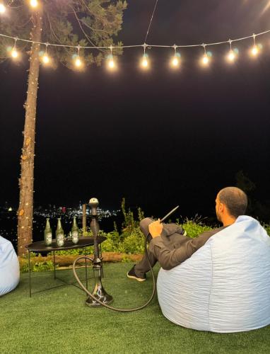 a man sitting on a bean bag chair under a stage at UpTown Batumi in Batumi